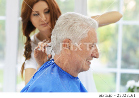Man having a haircut  from  hairdresser 25328161