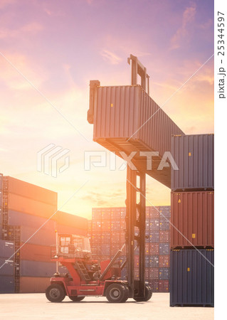 Forklift truck lifting cargo container 25344597