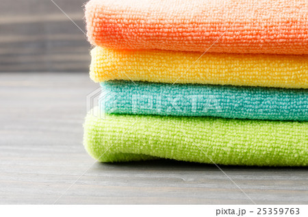 Colorful bath towels on wooden background closeup Colorful bath towels on wooden background closeup 25359763