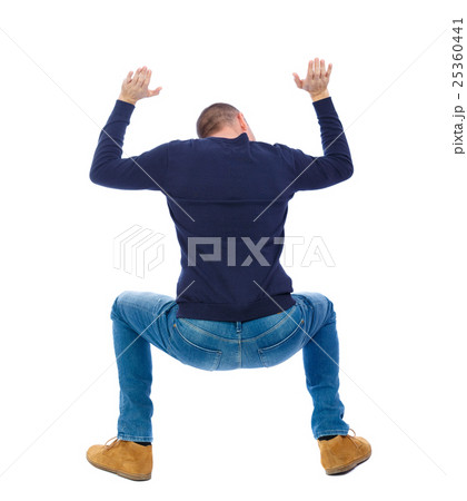 back view. man  protects hands from what is 25360441