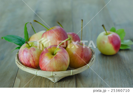 Red and yellow apple   on wooden background 25360710