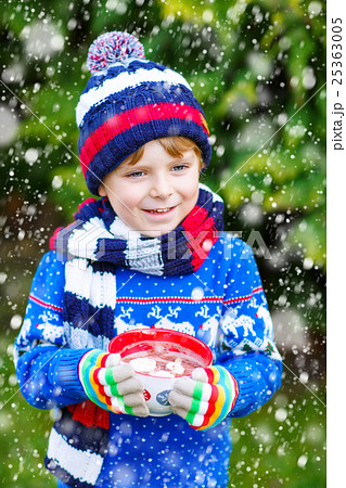 Little kid boy holding big cup with chocolate 25363005