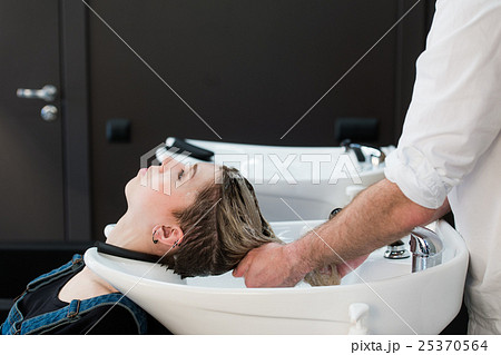Teenager girl washing hair in hairdressing salon. 25370564