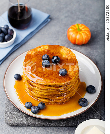 Pumpkin pancakes with maple syrup and blueberries 25372280