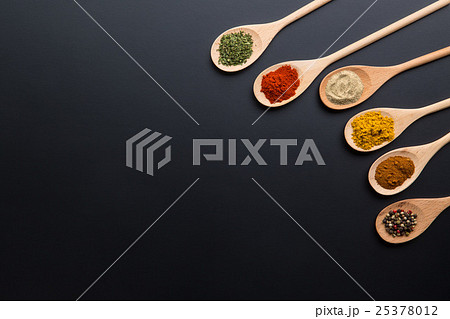 Various spices in wooden spoons. Various spices in wooden spoons. 25378012