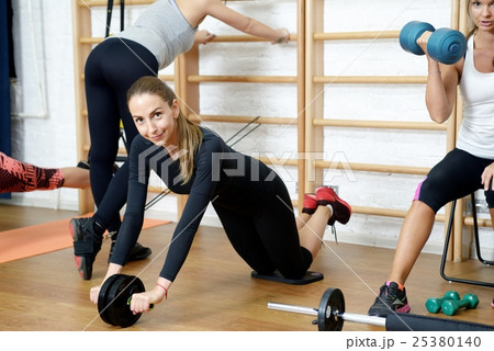 Group of girls doing fitness exercising in gym Group of girls doing fitness exercising in gym 25380140