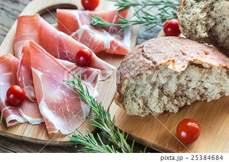 Slices of jamon on the wooden board 25384684