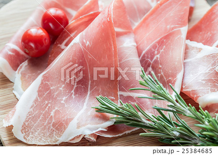 Slices of jamon on the wooden board Slices of jamon on the wooden board 25384685