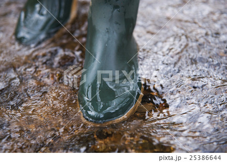 close up on rubber boots in the water close up on rubber boots in the water 25386644