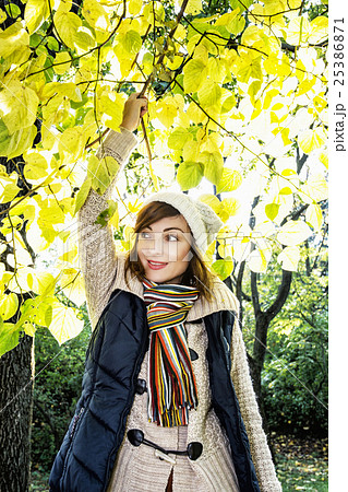 Beautiful smiling brunette posing under beech tree 25386871