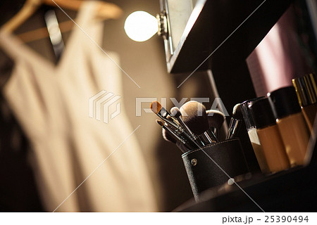 Beautician cosmetics near clothing in dressing 25390494