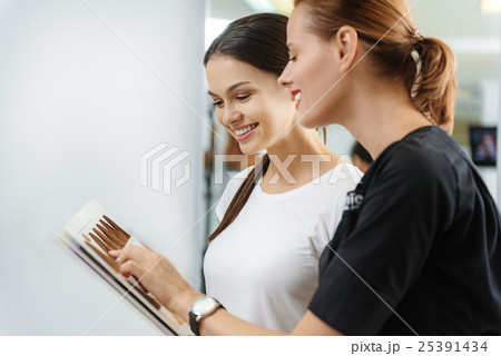 cheerful woman and customer standing in barbershop cheerful woman and customer standing in barbershop 25391434