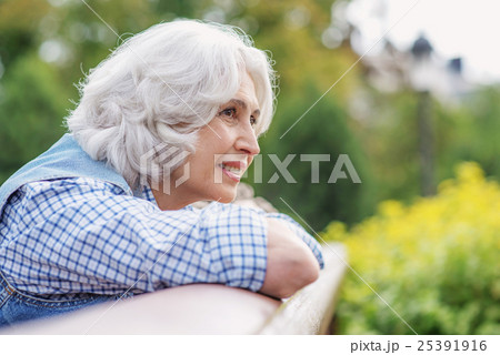 Dreamful old lady relaxing outdoors Dreamful old lady relaxing outdoors 25391916