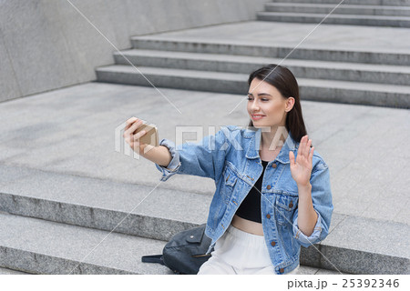 woman waves her hand on the street 25392346