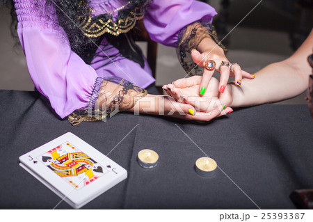 Sorceress reading somebody's hand Sorceress reading somebody's hand 25393387