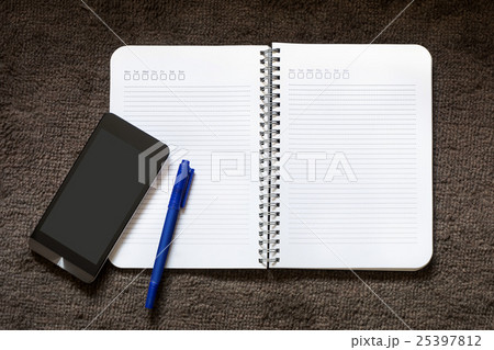 Paper Note with pen and mobile on the carpet 25397812
