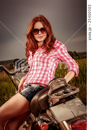 Biker girl sitting on motorcycle 25400503