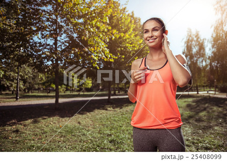 Cheerful girl listening to music before morning Cheerful girl listening to music before morning 25408099