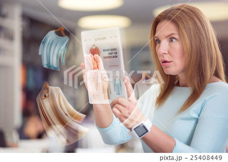 Surprised pleasant woman using tablet Surprised pleasant woman using tablet 25408449