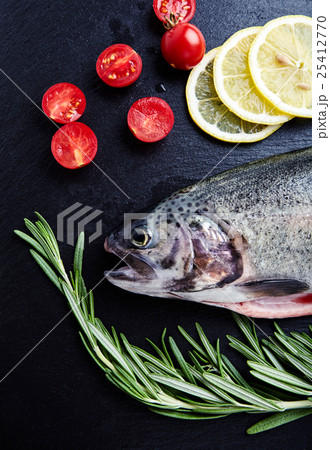 Fresh trout, tomatoes, lemon, rosemary 25412770