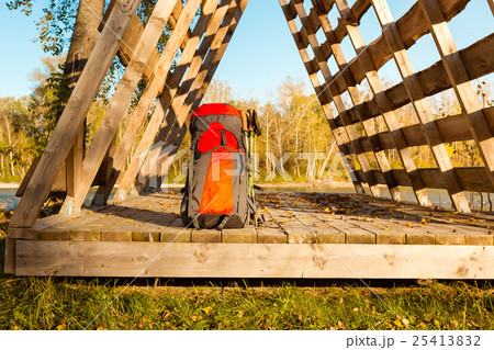 Tourist backpack lies on the edge of hut, in light 25413832