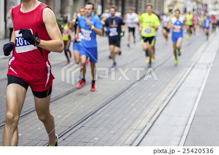 Marathon runners race in city streets 25420536