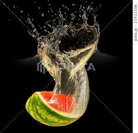 Fresh melon falling in water with splash on black 25422106