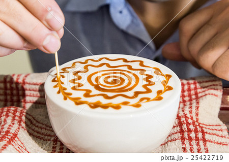 Series of person decorating coffee with art 25422719