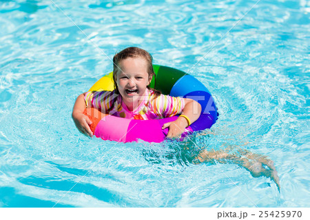 Little girl with toy ring in swimming pool Little girl with toy ring in swimming pool 25425970
