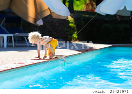 Little child jumping into swimming pool Little child jumping into swimming pool 25425971