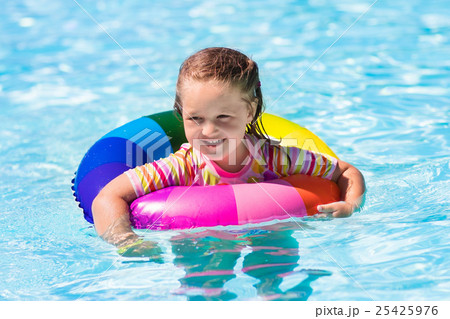 Little girl with toy ring in swimming pool 25425976