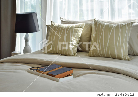 decorative tray and striped pillows on bed decorative tray and striped pillows on bed 25435612