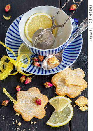 Italian cookies Canestrelli,lemon and tea cup. Italian cookies Canestrelli,lemon and tea cup. 25446641