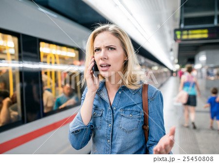 Woman making phone call at the underground 25450808