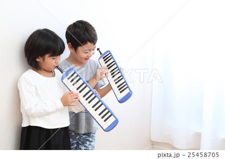 鍵盤ハーモニカを練習する小学生 25458705