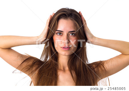 Woman holding hands at her head Woman holding hands at her head 25485005