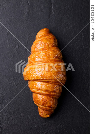 Fresh croissant Black slate background. Top view 25485101