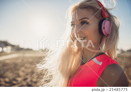 Portrait of young beautiful woman listening to Portrait of young beautiful woman listening to 25485775
