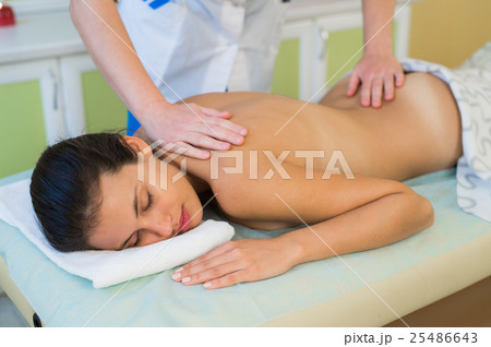 Beautiful young woman relaxing with hand massage 25486643