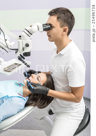 Dentist with patient in clinic 25496738