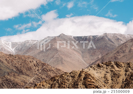 Top of rock mountain in blue cloud sky 25500009