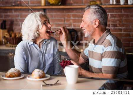 Elderly man feeding his lovely wife Elderly man feeding his lovely wife 25501411