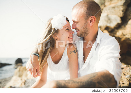Young models couple posing on the beach with Young models couple posing on the beach with 25503706