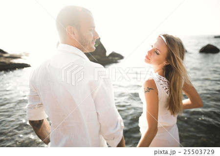 Fashion model couple with tattoo posing outside Fashion model couple with tattoo posing outside 25503729