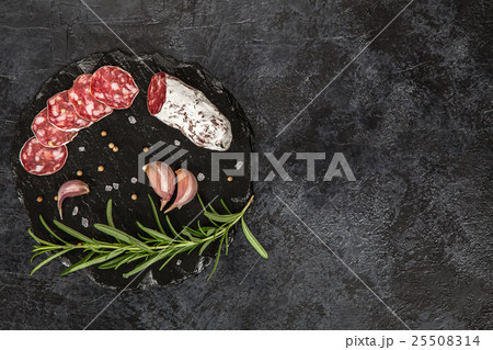 Salami on dark background Salami on dark background 25508314