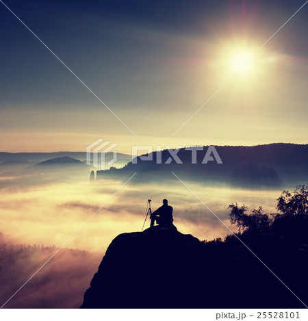Photographer thinking. Dreamy fogy landscape 25528101