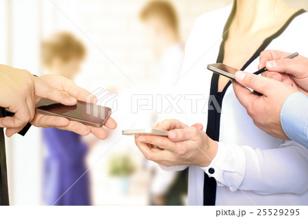 Business men and woman using mobile smart phones Business men and woman using mobile smart phones 25529295