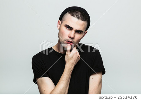 Studio portrait of man with hand on chin 25534370