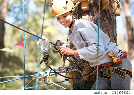 Pretty joyful woman fastening the carabiner 25534839