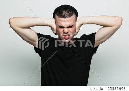 Male squinting with force to back away from what 25535963